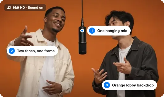 Two friends rapping into one hanging microphone in an orange Hotel Lobby booth